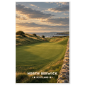 Links golf green beside a dry-stone wall and dunes above the sea at sunset in North Berwick, Scotland