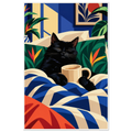 Sleepy black cat in bed holding a mug of coffee among tropical pillows and a blue striped duvet